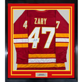 Framed Autographed/Signed Connor Zary 35x39 Calgary Red Hockey Jersey Beckett BAS COA